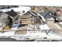 Ranch home with golf course views in a snow covered neighborhood at 8171 S Catawba Ct, Aurora, CO 80016