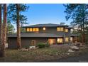 Stunning multi-level home showcasing unique architectural details and lush landscaping on a spacious lot at 28890 Pinewood Vista Dr, Evergreen, CO 80439
