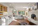 Bright living room with a fireplace, sky light and large windows offering scenic views at 28890 Pinewood Vista Dr, Evergreen, CO 80439