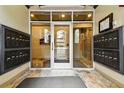 Well-lit condo entryway with mailboxes and secure access, ensuring convenience for residents at 40 Madison St # 203, Denver, CO 80206