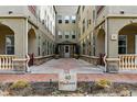 Condo exterior with lovely architecture featuring a landscaped courtyard leading to the main entrance at 40 Madison St # 203, Denver, CO 80206