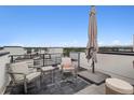 Outdoor rooftop patio area featuring chairs, an umbrella, and open views at 1284 Quitman St, Denver, CO 80204