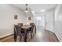 Inviting dining room with hardwood floors, a modern light fixture, and a view of the staircase at 5415 W 16Th Ave, Lakewood, CO 80214
