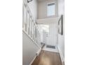 Bright entryway with tile flooring, a staircase, and a welcoming white door, showcasing a clean and modern design at 5415 W 16Th Ave, Lakewood, CO 80214