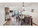 Open-concept living area with hardwood floors, a bay window, and a seamless flow to the kitchen at 5415 W 16Th Ave, Lakewood, CO 80214