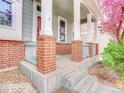 Inviting front porch with brick accents and sturdy white support columns at 12948 E 106Th Way, Commerce City, CO 80022
