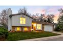 Charming two-story home featuring brick accents and a well-maintained front lawn at 8512 W Star Cir, Littleton, CO 80128