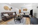 Inviting living room features wood floors, neutral walls, decorative elements, and comfortable seating arrangement at 2227 Canyon Blvd # 162B, Boulder, CO 80302