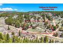 Property outline for illustrative purposes in an aerial view of a secluded red home and outbuilding at 548 Coughlin Meadows Rd, Boulder, CO 80302