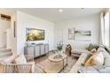 Cozy living room featuring stylish furnishings, a mounted TV, and neutral decor at 22315 E 6Th Ave, Aurora, CO 80018
