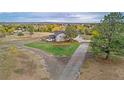 Aerial view showing house, driveway, and surrounding landscape at 12628 N 3Rd St, Parker, CO 80134