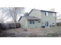 View of home's backyard with mature trees and patio at 9852 W 76Th Ave, Arvada, CO 80005