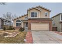 View of the exterior featuring a two-car garage and landscaped front yard at 5300 Morning Glory Pl, Highlands Ranch, CO 80130