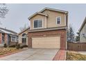 View of the exterior featuring a two-car garage and manicured front yard at 5300 Morning Glory Pl, Highlands Ranch, CO 80130