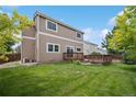 Spacious backyard with a well-maintained lawn and a wooden deck, great for entertaining at 2446 S Gibralter Way, Aurora, CO 80013