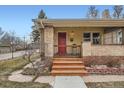 Close-up of the cozy front porch with a red door, offering a warm and inviting entrance at 2901 Ames St, Wheat Ridge, CO 80214