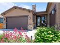 Inviting one-story home with well-kept lawn and garden beds leading to the covered entry at 11136 Sweet Cicely Dr, Parker, CO 80134
