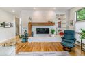 Modern living room with a striking fireplace, wood floors, and stylish decor at 4274 E Dickenson Pl, Denver, CO 80222