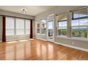 Bright living room with hardwood floors, large windows, and access to the outdoor deck at 1975 Wild Star Way, Castle Rock, CO 80104