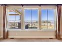 A close up of windows that provide a view of the treeline and fencing at 1975 Wild Star Way, Castle Rock, CO 80104