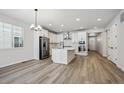 Modern kitchen features stainless steel appliances and an island at 1382 Zenith Heights Ct, Erie, CO 80516