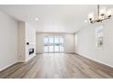 Spacious living room with fireplace and sliding glass doors to backyard at 1382 Zenith Heights Ct, Erie, CO 80516