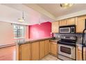 Well-lit kitchen area with stainless steel oven, microwave, and granite countertops at 1833 N Williams St # 402, Denver, CO 80218