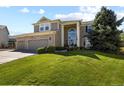 Charming two-story home with a three-car garage and a well-maintained front lawn at 11839 Saddleback Ct, Parker, CO 80138