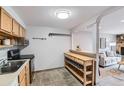 Bright kitchen featuring light wood cabinetry, stainless appliances, and an open design with breakfast bar at 1008 N Corona St # 205, Denver, CO 80218