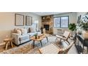 Cozy living room featuring a stone fireplace, large windows, and contemporary furnishings at 1008 N Corona St # 205, Denver, CO 80218