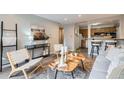 Open-concept living room with natural wood accents, adjacent to a kitchen with bar seating at 1008 N Corona St # 205, Denver, CO 80218