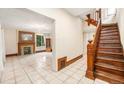 Foyer view featuring a beautiful hardwood staircase, tiled floors and a view into the living room at 7 Elati St, Denver, CO 80223