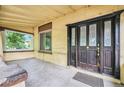 Inviting front porch featuring a beautiful ornate door, large window, and concrete floor at 7 Elati St, Denver, CO 80223