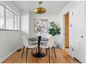 Cozy dining room with hardwood floors, a round table, and modern lighting fixture at 2975 S Jackson St, Denver, CO 80210
