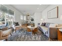 Bright living room with hardwood floors, stylish furnishings, and a large window that provides natural light at 2975 S Jackson St, Denver, CO 80210