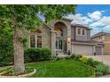Charming two-story home with landscaped front yard, arched entryway and a three car garage at 9552 E Caley Cir, Englewood, CO 80111