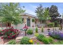 Charming single-story home with a lush, well-manicured front yard and mature trees at 250 W Midway Blvd, Broomfield, CO 80020
