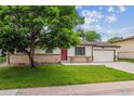 Charming ranch-style home featuring a cozy front porch, well-maintained lawn, and attached garage at 6508 S Garland Way, Littleton, CO 80123