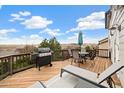 Outdoor deck area featuring a grill, outdoor furniture, seating, and scenic views at 11980 Swansea Dr, Parker, CO 80134