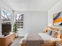 Comfortable bedroom with natural light, plush bedding, and stylish decor at 6852 S Dover Way, Littleton, CO 80128