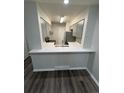 An updated, neutral colored kitchen with modern appliances and a breakfast bar at 2280 S Jasper Way # A, Aurora, CO 80013