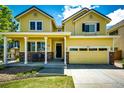 Inviting front exterior featuring a covered porch, a two-car garage, and a well-maintained lawn at 4970 Laurelglen Ln, Highlands Ranch, CO 80130