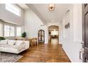 Bright living room with high ceilings, hardwood floors, large windows and modern furnishings at 4970 Laurelglen Ln, Highlands Ranch, CO 80130