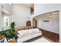 Spacious living room with high ceilings, hardwood floors, and open layout, perfect for entertaining at 4970 Laurelglen Ln, Highlands Ranch, CO 80130