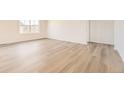 Bright and airy bedroom featuring hardwood floors, a large window, and neutral paint, creating a serene atmosphere at 22015 E 39Th Ave, Aurora, CO 80019