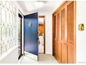 Welcoming entryway featuring decorative tile floors and unique front door at 950 Everett St, Lakewood, CO 80215