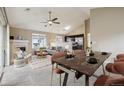 Open concept living space featuring a dining area, fireplace, and modern furnishings at 3262 E 103Rd Dr # 1806, Thornton, CO 80229