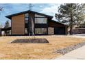 Contemporary home with a well-maintained front yard and modern design elements at 1390 S Jasmine Way, Denver, CO 80224