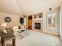 Comfortable living room featuring a fireplace and large window at 13990 E Chenango Dr, Aurora, CO 80015
