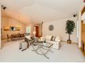 Bright living room with vaulted ceilings, modern furniture, and an open concept design at 13990 E Chenango Dr, Aurora, CO 80015